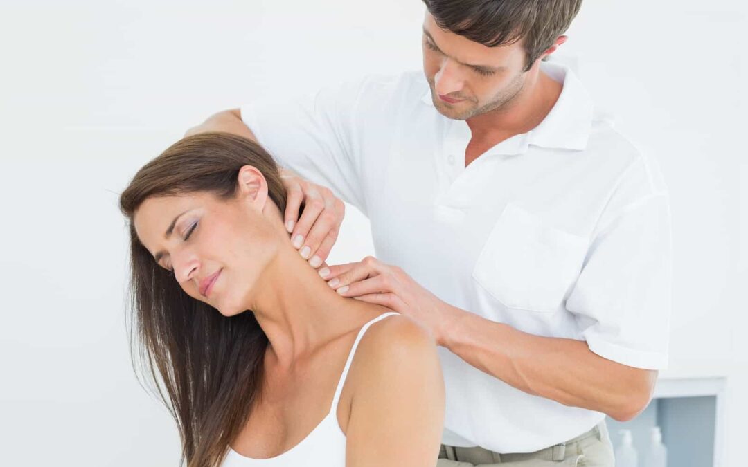 Doctor massaging patient’s neck