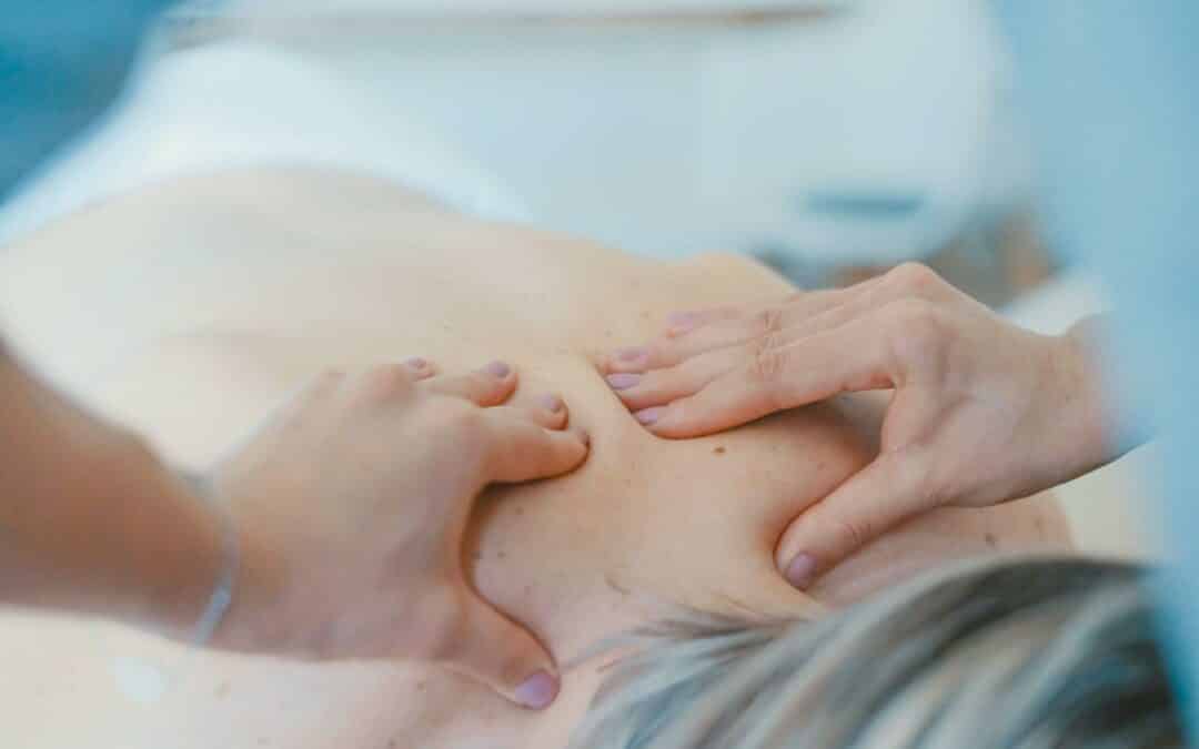 Chiropractor massaging woman
