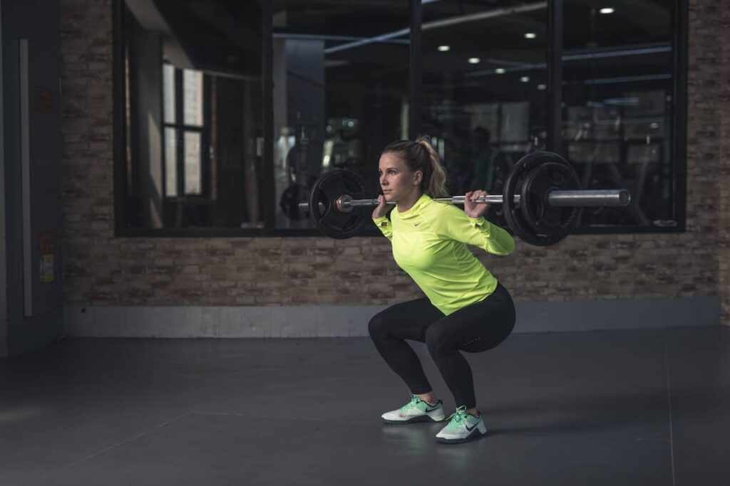 Woman performing barbell squat